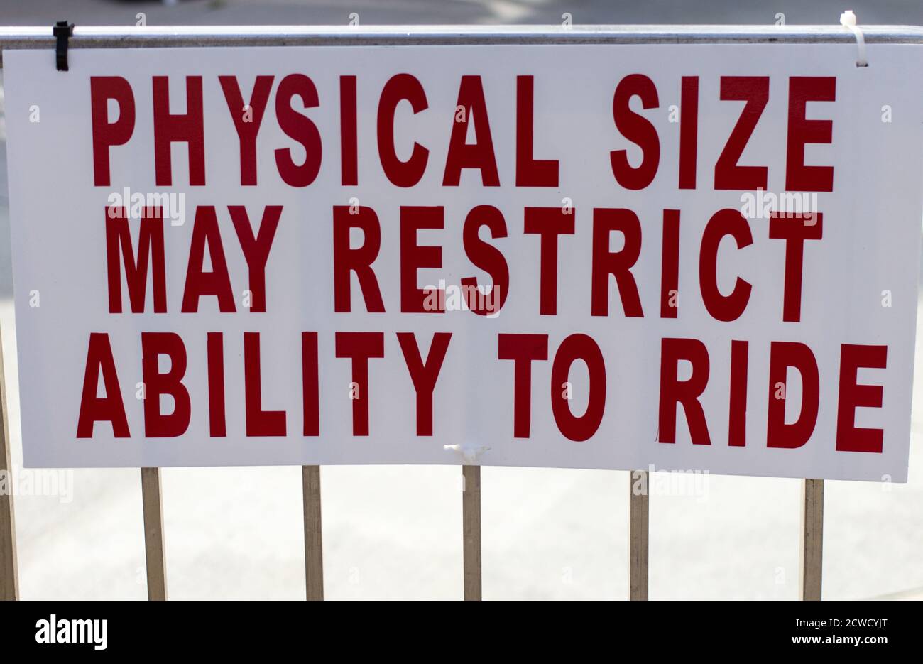 Sign posting restrictions for obese riders at an amusement park on thrill rides and roller coasters. Stock Photo