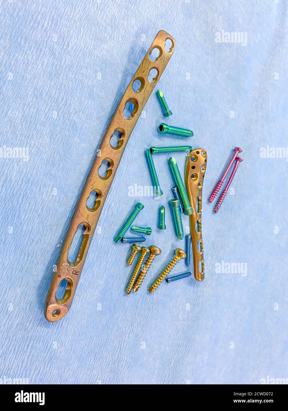 explanted titanium screws and titanium plates in different colors and