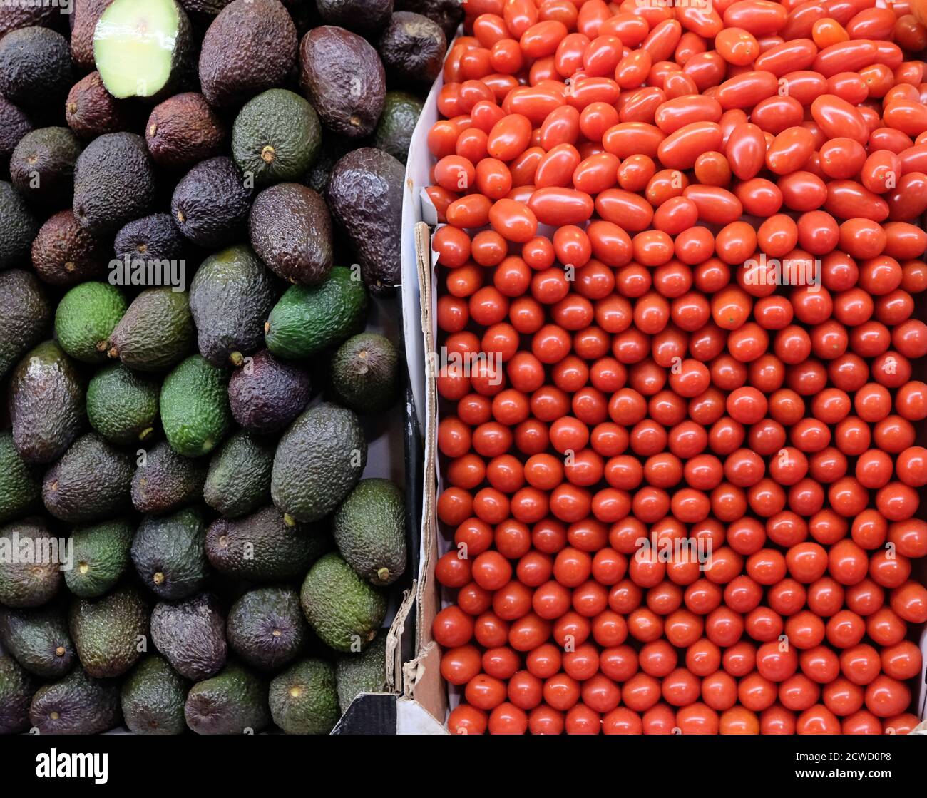 Nicely stacked tomatoes and avocados on a truck Stock Photo