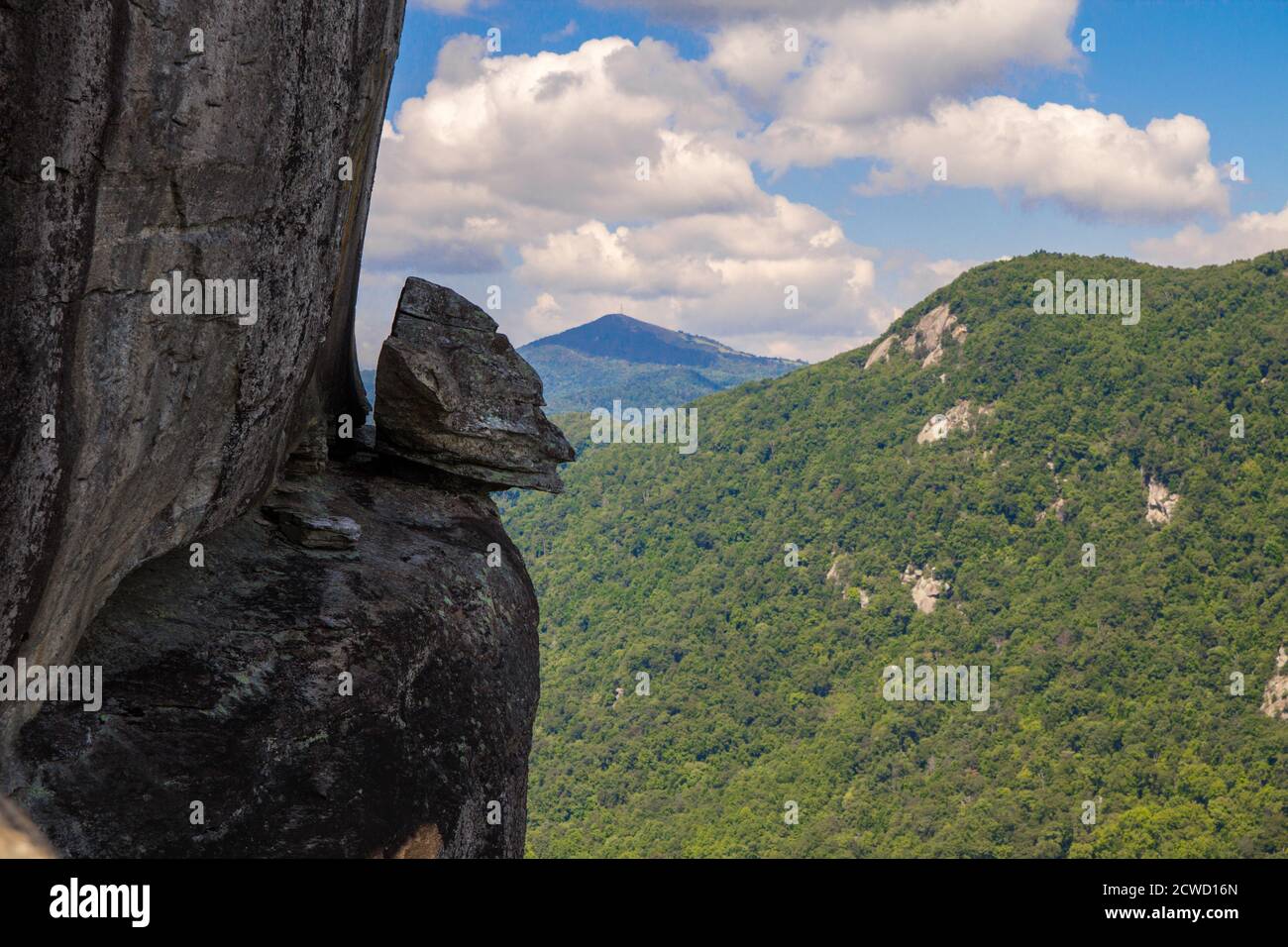 Devils Head rock on the edge a steep cliff at Chimney Rock State Park in the Appalachian Mountains of North Carolina. Stock Photo
