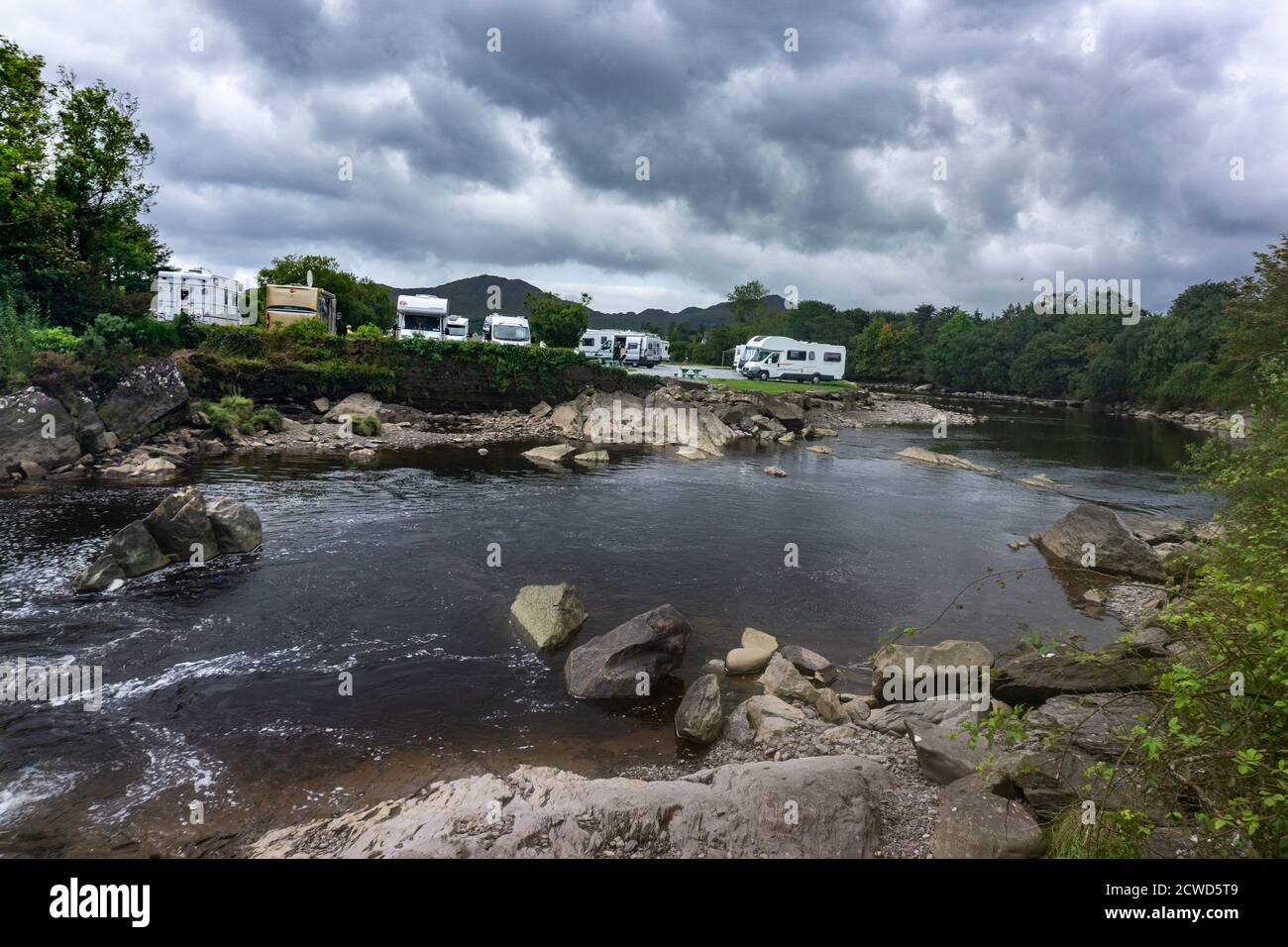 Camper vans parked near the centre of the village of Sneem, County Kerry, Ireland, along the banks of Sneem river. Stock Photo