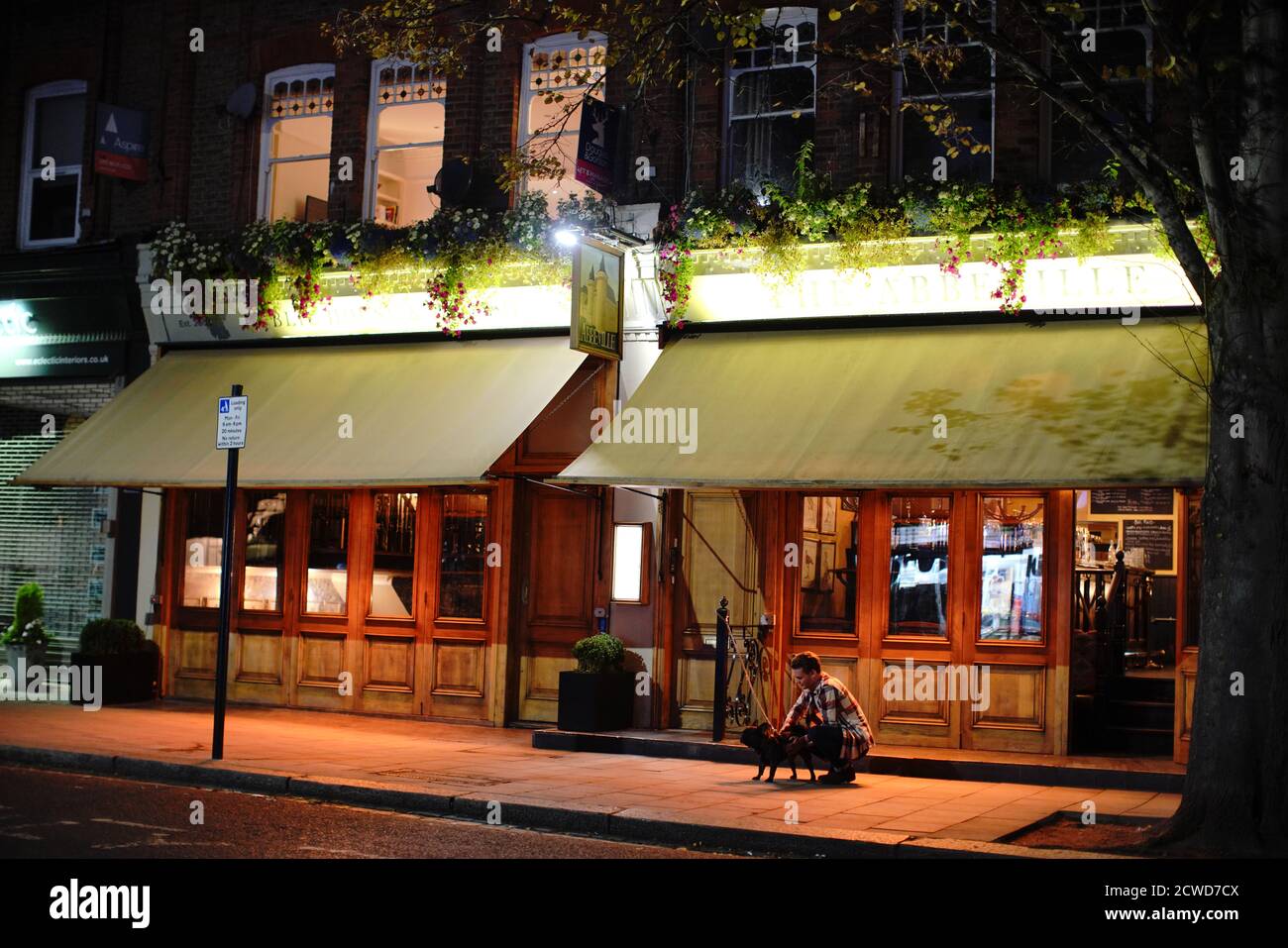 People outside the Abbeyville in Clapham Common in London, at 21:48hrs, after a range of new restrictions to combat the rise in coronavirus cases came into place in England. Stock Photo