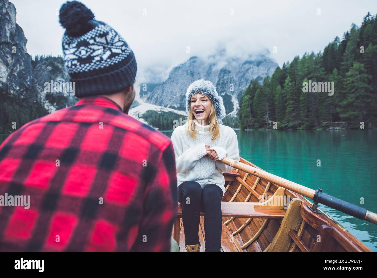 Couple on wooden boat having fun on alpine lake Stock Photo