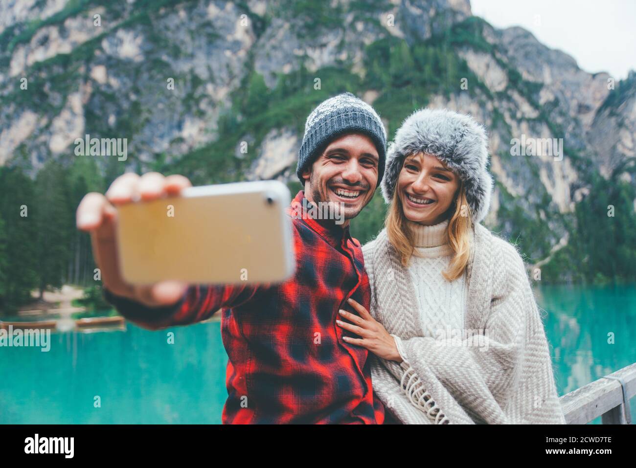 Mountain stories. Happy couple on a wanderlust vacation. Boyfriend and girlfriend spending time together at the lake. Storytelling concept about lifes Stock Photo