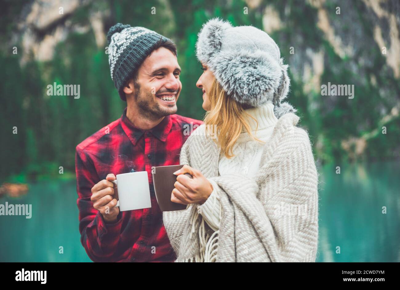 Mountain stories. Happy couple on a wanderlust vacation. Boyfriend and girlfriend spending time together at the lake. Storytelling concept about lifes Stock Photo