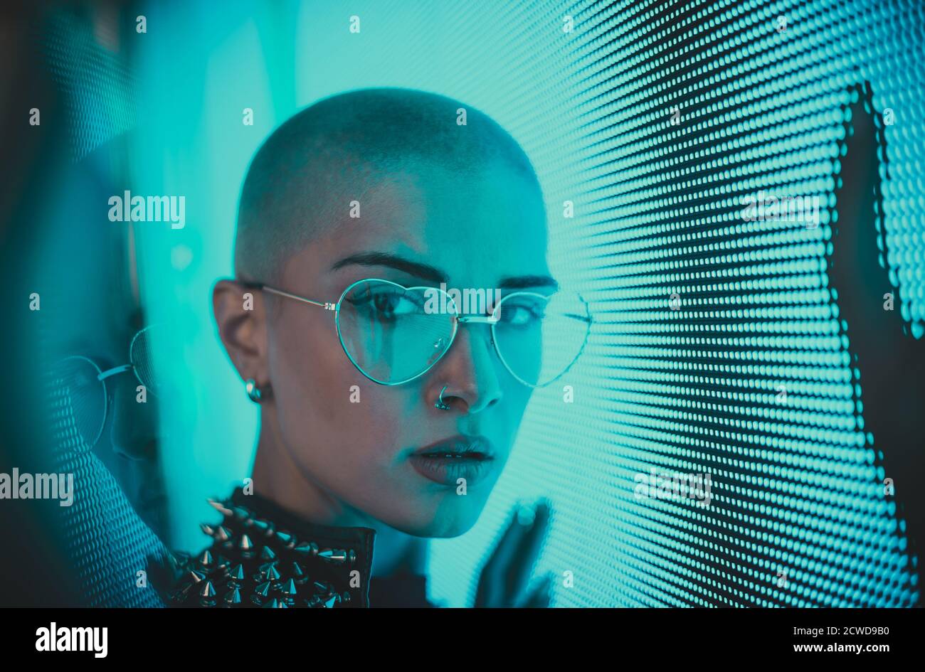 Image Of A Beautiful Young Woman Posing Against A Led Panel Shaved