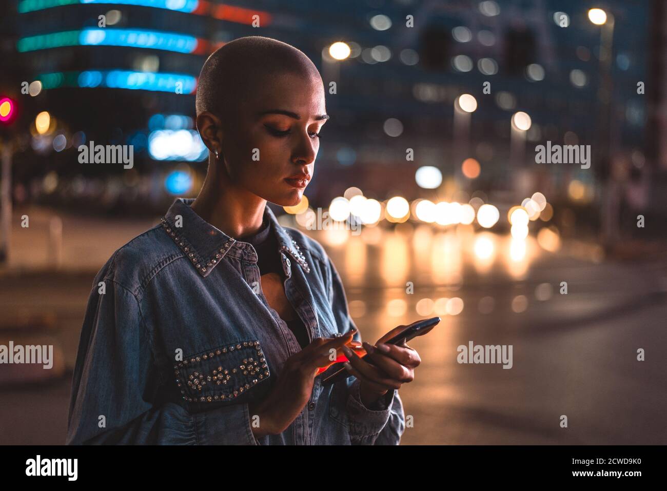 Image of a young woman using mobile phone on the street. Girl with ...