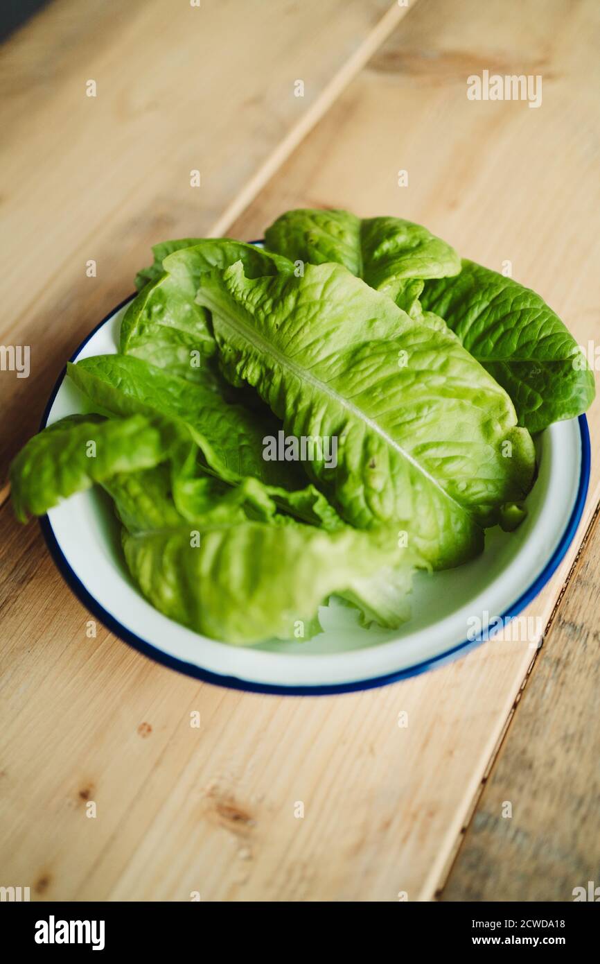 Bowl of salad leaves on a wooden table Stock Photo
