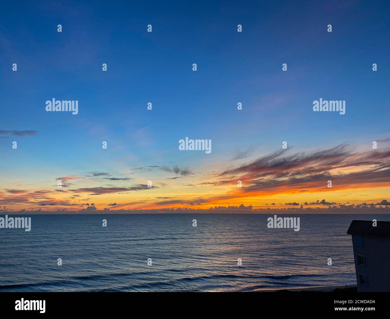 An orange and blue sunrise over the Atlantic Ocean on a beautiful ...
