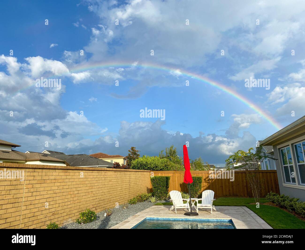 A rainbow in a backyard with a pool in Orlando, Florida Stock Photo Alamy