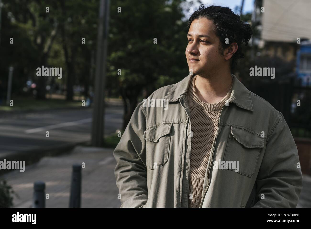 Beautiful portrait of a young man walking down the street Stock Photo