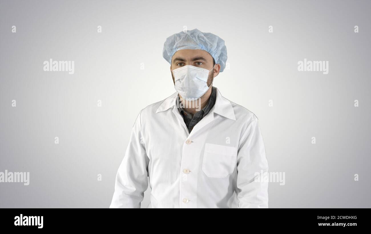 Mature surgery in a mask walking Front view on gradient backgrou Stock Photo