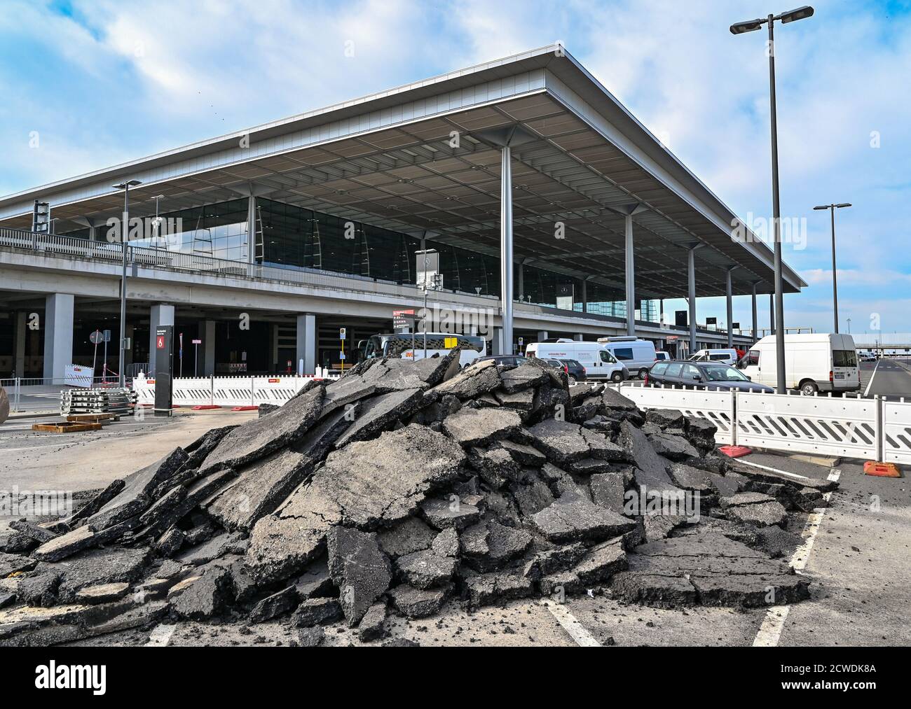 29 September 2020, Brandenburg, Schönefeld: Remains of torn road surface are located in front of the main terminal of the Berlin Brandenburg Airport 'Willy Brandt' (BER). The capital city airport BER on the border to Berlin is scheduled to open on 31.10.2020. Photo: Patrick Pleul/dpa-Zentralbild/dpa Stock Photo