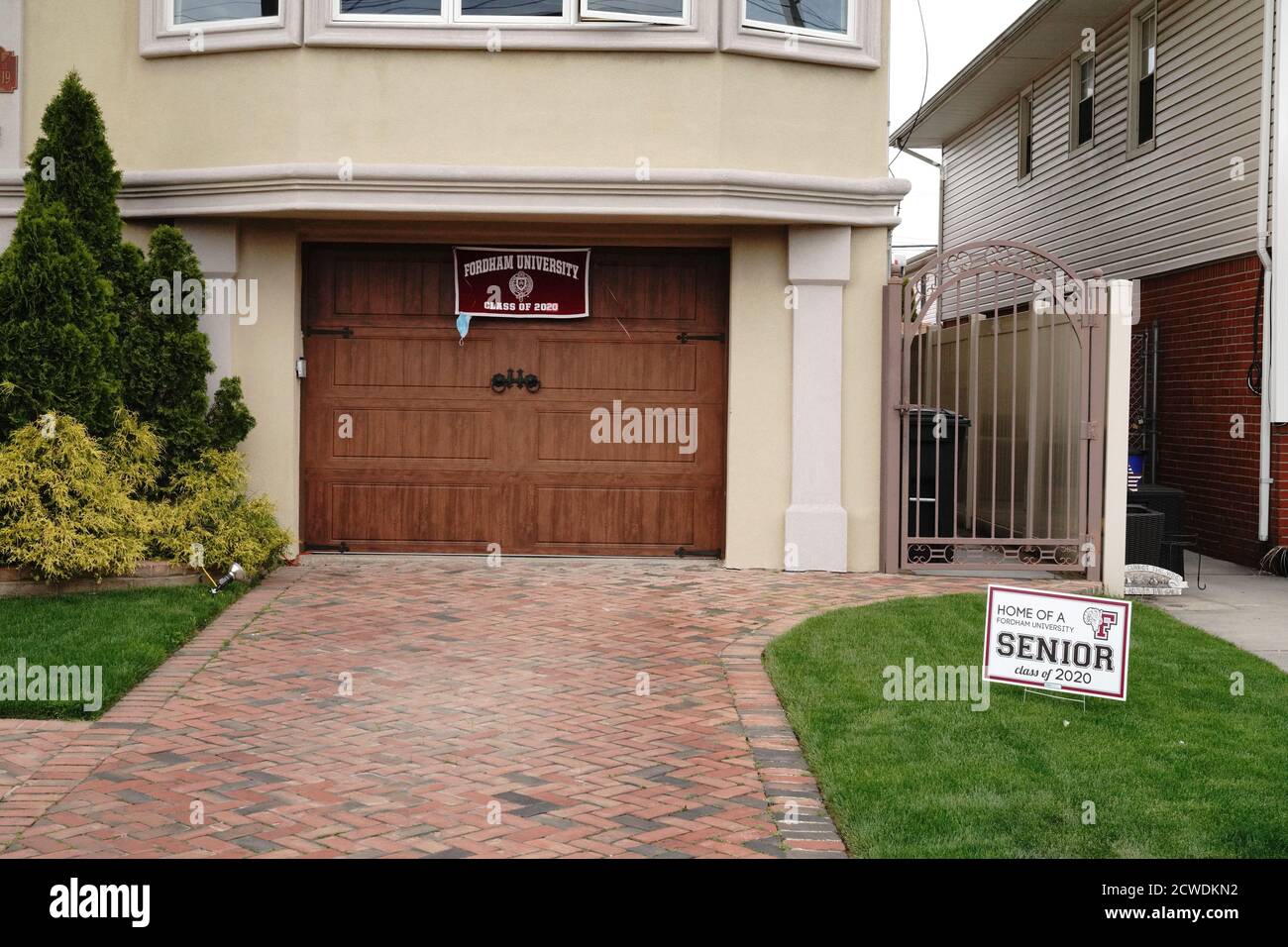 A home with congratulatory sign for graduates at Howard Beach, Borough of Queens in New York City. Stock Photo