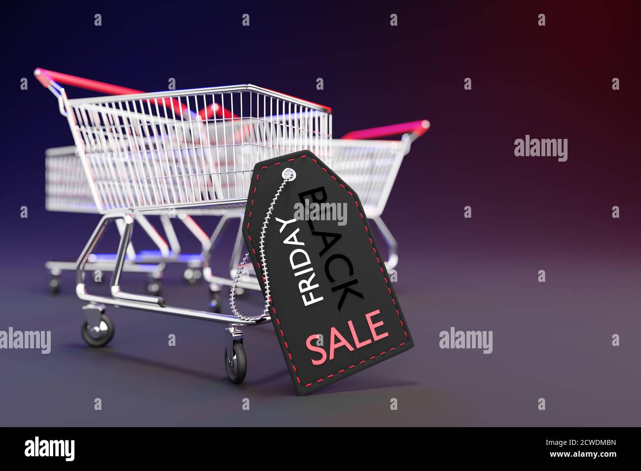 Black price tag is leaning against a shopping cart in a dark background. Concept of shopping season on weekends of November every year. Closeup and co Stock Photo
