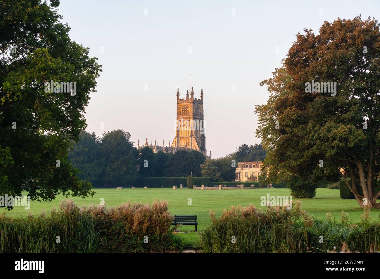 The Church of St. John the Baptist from the abbey grounds at sunrise. Cirencester, Cotswolds, Gloucestershire, England Stock Photo