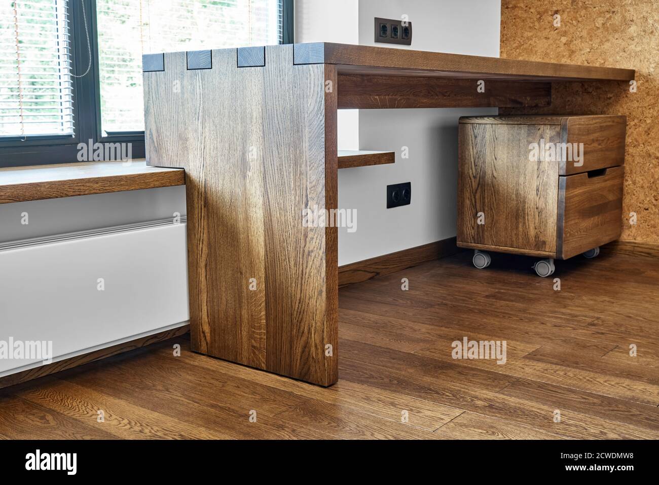 Modern furniture. Box joint solid wooden console desk against the