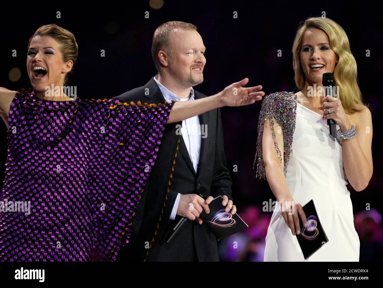 German TV entertainers and host of the Eurovision, Judith Rakers (R) Stefan Raab and Anke Engelke (L) pose during the first semi-final for the Eurovison Song Contest in Duesseldorf May 10, 2011. The 2011 Eurovison Song Contest will be held in the western German city of Duesseldorf on May 14.       REUTERS/Wolfgang Rattay (GERMANY  - Tags: ENTERTAINMENT) Stock Photo