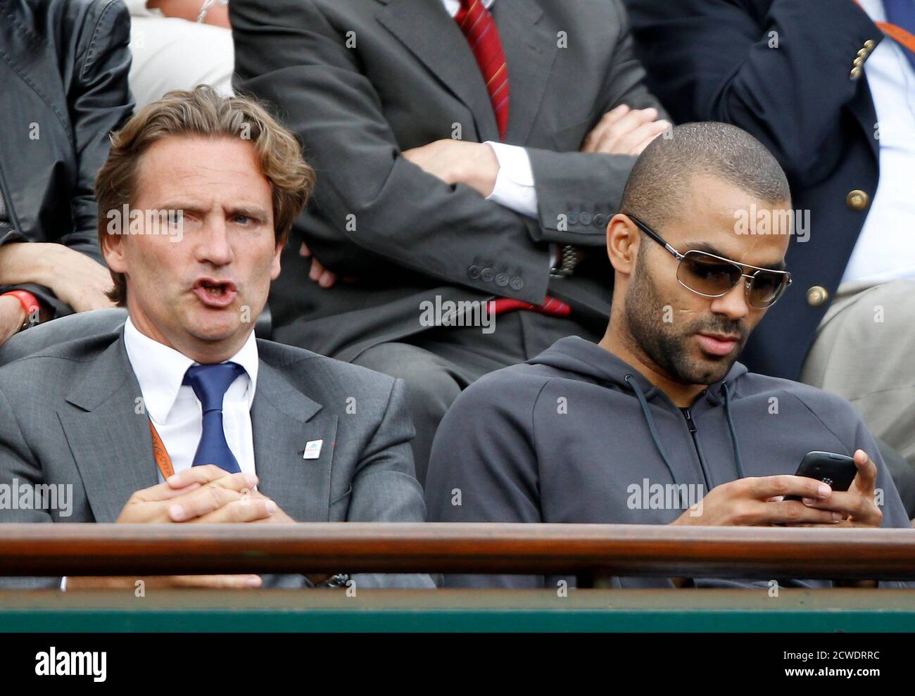 Basketball player Tony Parker (R) and Annecy 2018 Winter Olympic bid  President Charles Beigbeder attend the match between Jo-Wilfried Tsonga of  France and Stanislas Wawrinka of Switzerland during the French Open tennis