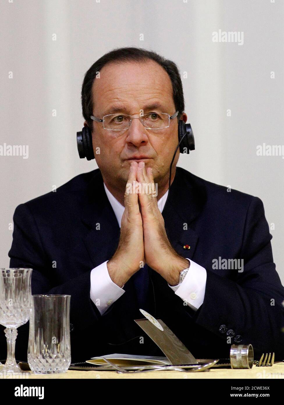French President Francois Hollande listens ahead of a gala dinner at the State Guest House in Pretoria October 14, 2013. France will lend 100 million euros ($135 million) to South African state power utility Eskom to help it finance solar power projects in Africa's largest economy, according to a communique obtained by Reuters on Monday. The deal will be signed as a part of a summit between Hollande and South Africa's President Jacob Zuma, which started on Monday in Pretoria. REUTERS/Siphiwe Sibeko (SOUTH AFRICA - Tags: POLITICS ENERGY BUSINESS) Stock Photo