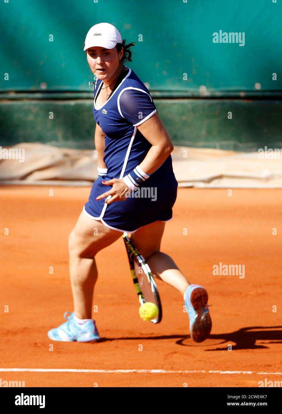 Ons Jabeur of Tunisia hits a return between her legs to von Deichmann of Liechtenstein during their women's singles semi-final match at the Nana Trophy international tennis tournament in Tunis May
