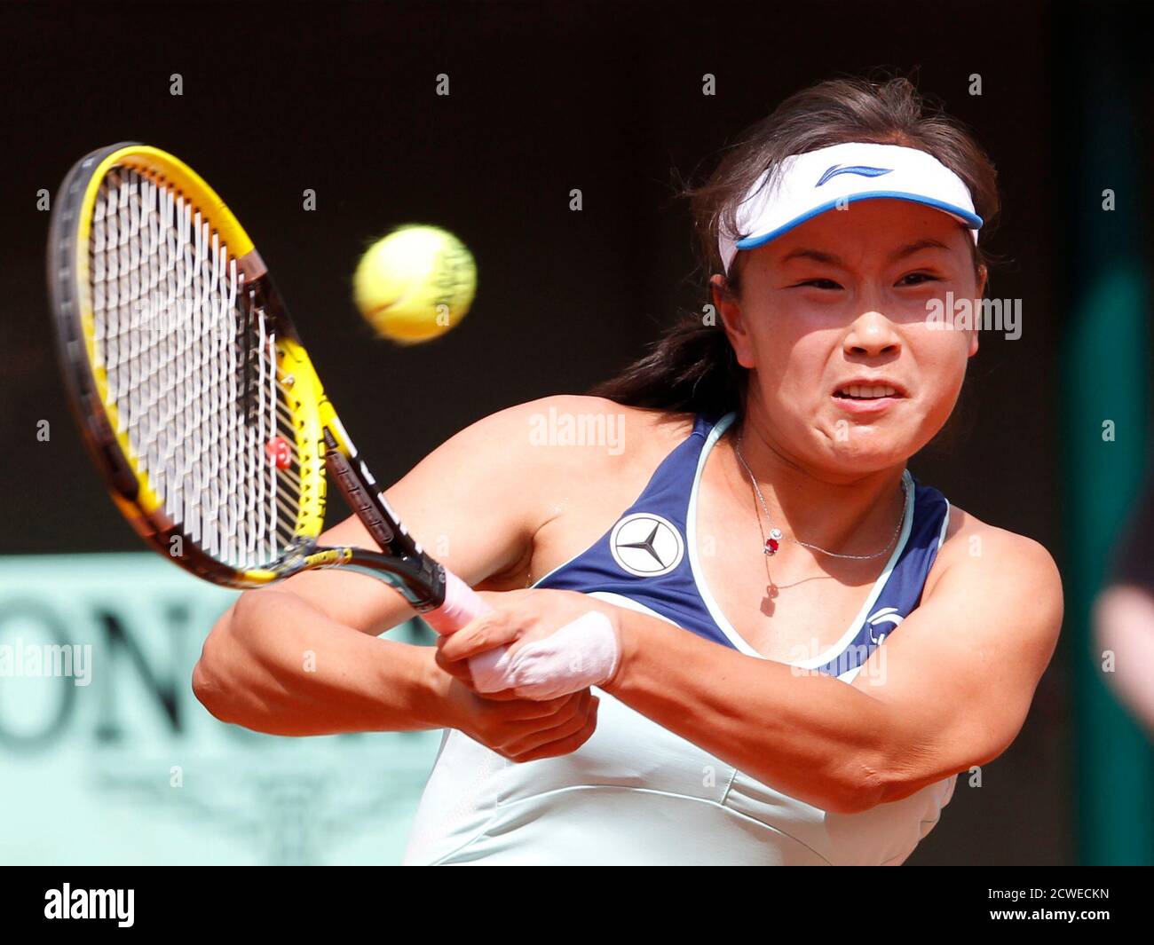 Peng Shuai of China returns the ball to Maria Sharapova of Russia during  the French Open tennis tournament at the Roland Garros stadium in Paris  June 2, 2012. REUTERS/Regis Duvignau (FRANCE -
