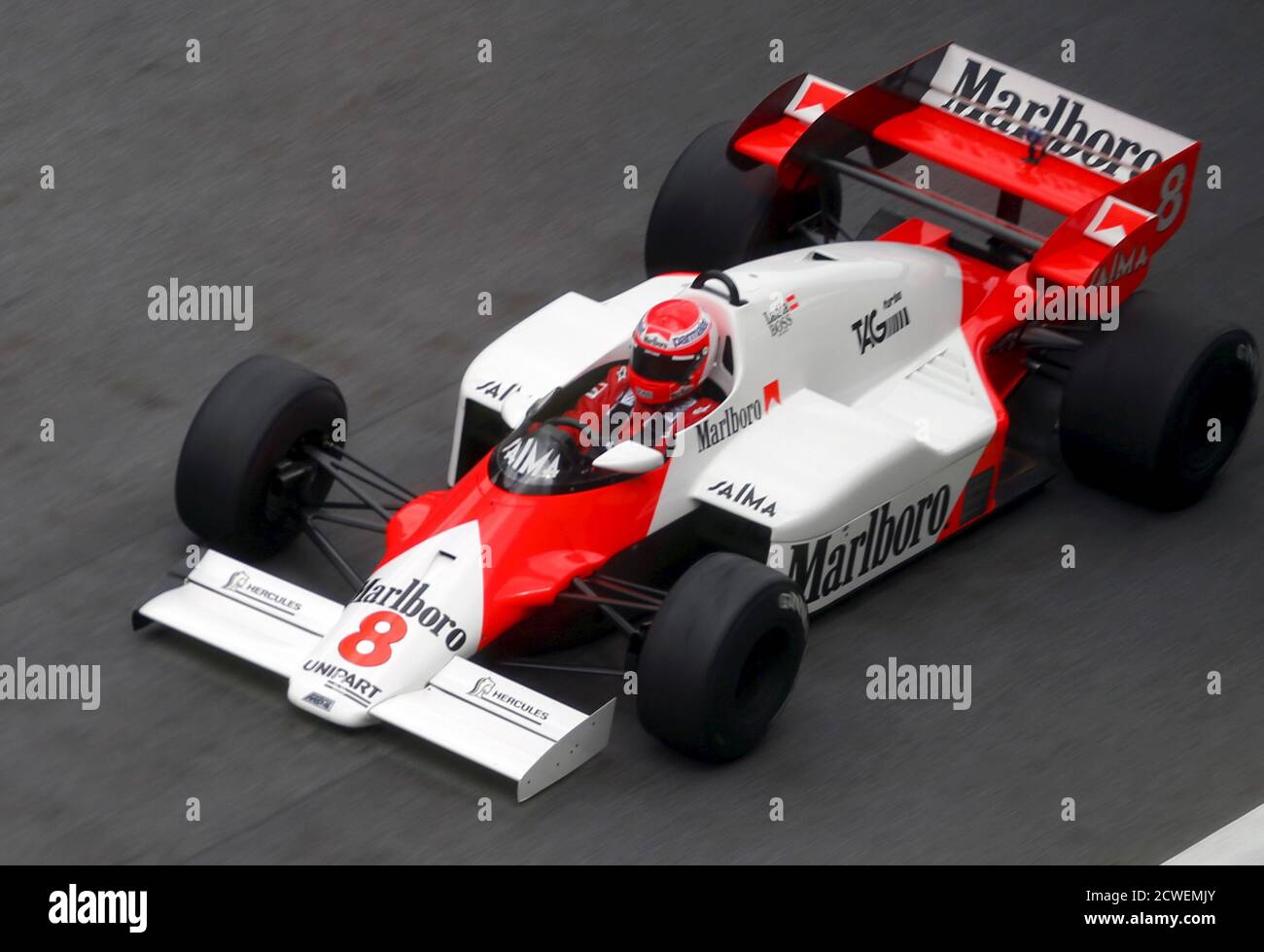 Former three-times Formula One World Champion Niki Lauda of Austria drives  in the winning McLaren MP4/2 of his times before the start of the Austrian  F1 Grand Prix at the Red Bull