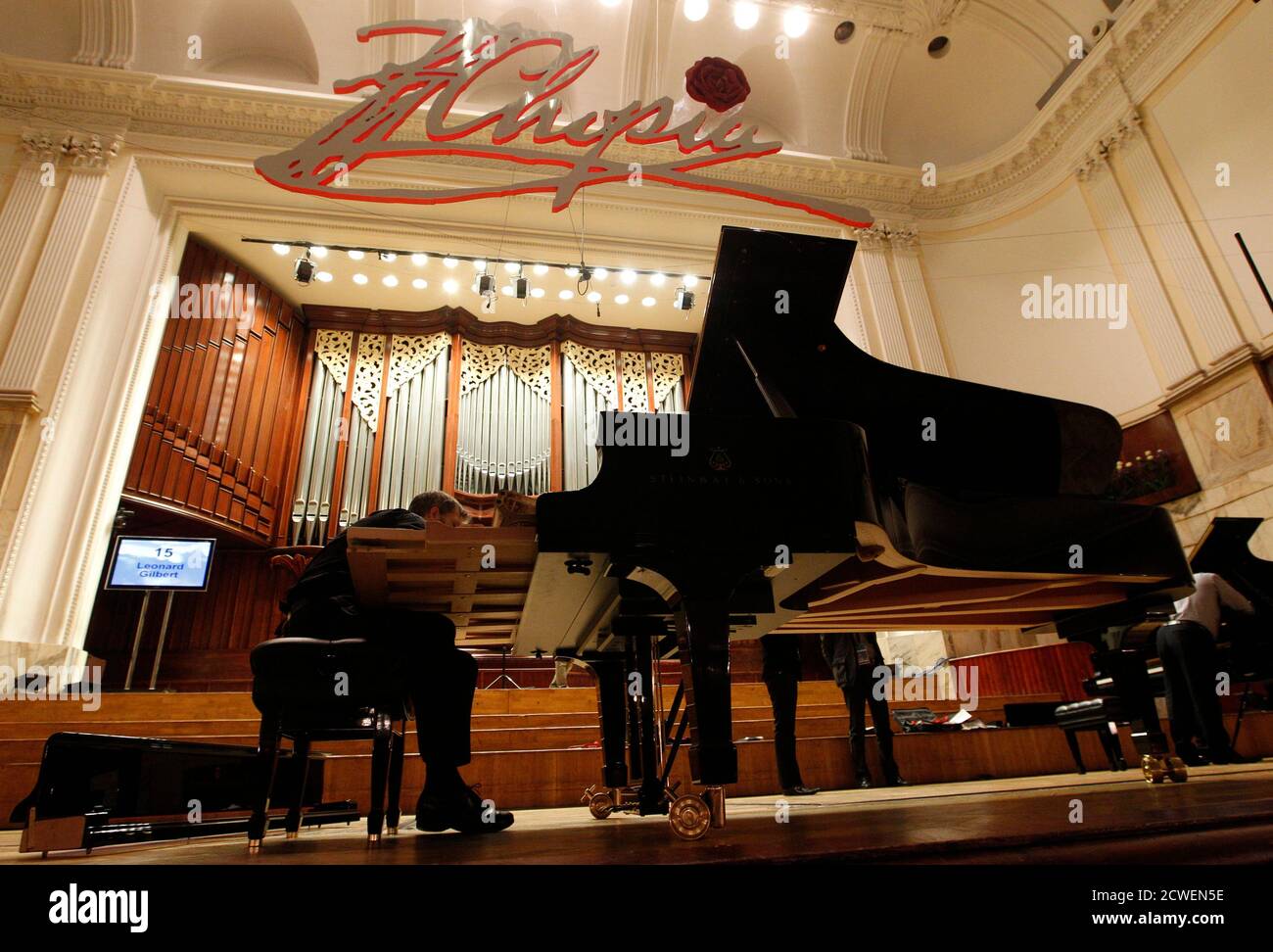 A man tunes a piano during a technical break on the first day of auditions  at the 16th International Fryderyk Chopin Piano Competition at Warsaw  Philharmonic Concert Hall October 3, 2010. REUTERS/Peter