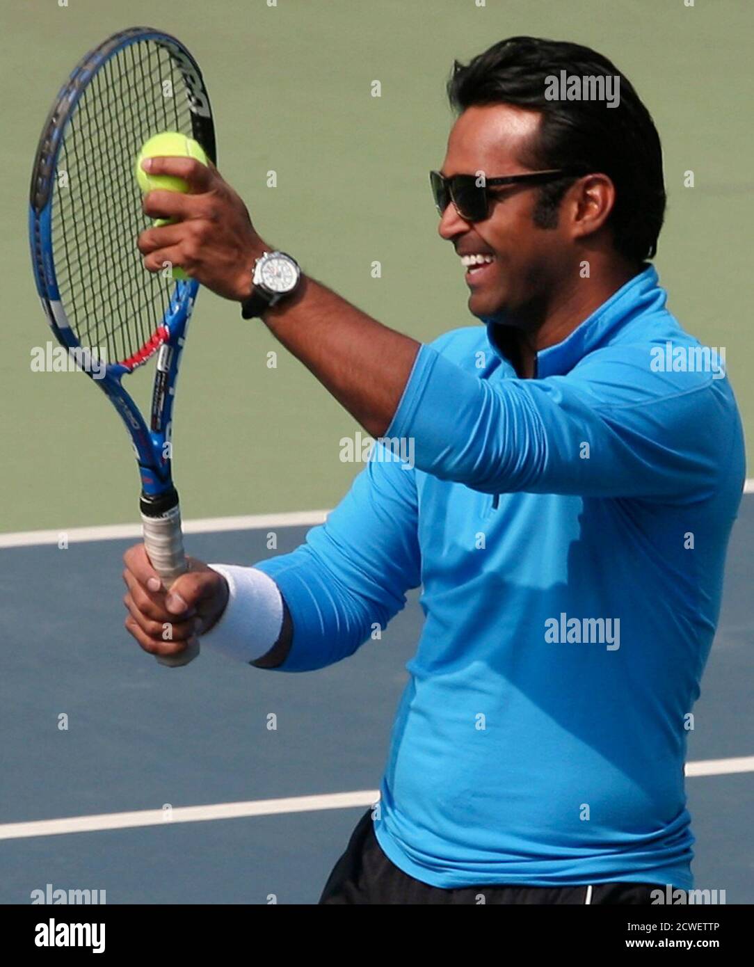 India's tennis player Leander Paes laughs during an interaction with  budding tennis players at the Delhi Lawn Tennis Association (DLTA) stadium  in New Delhi February 5, 2012. London's Olympics offer the Paes