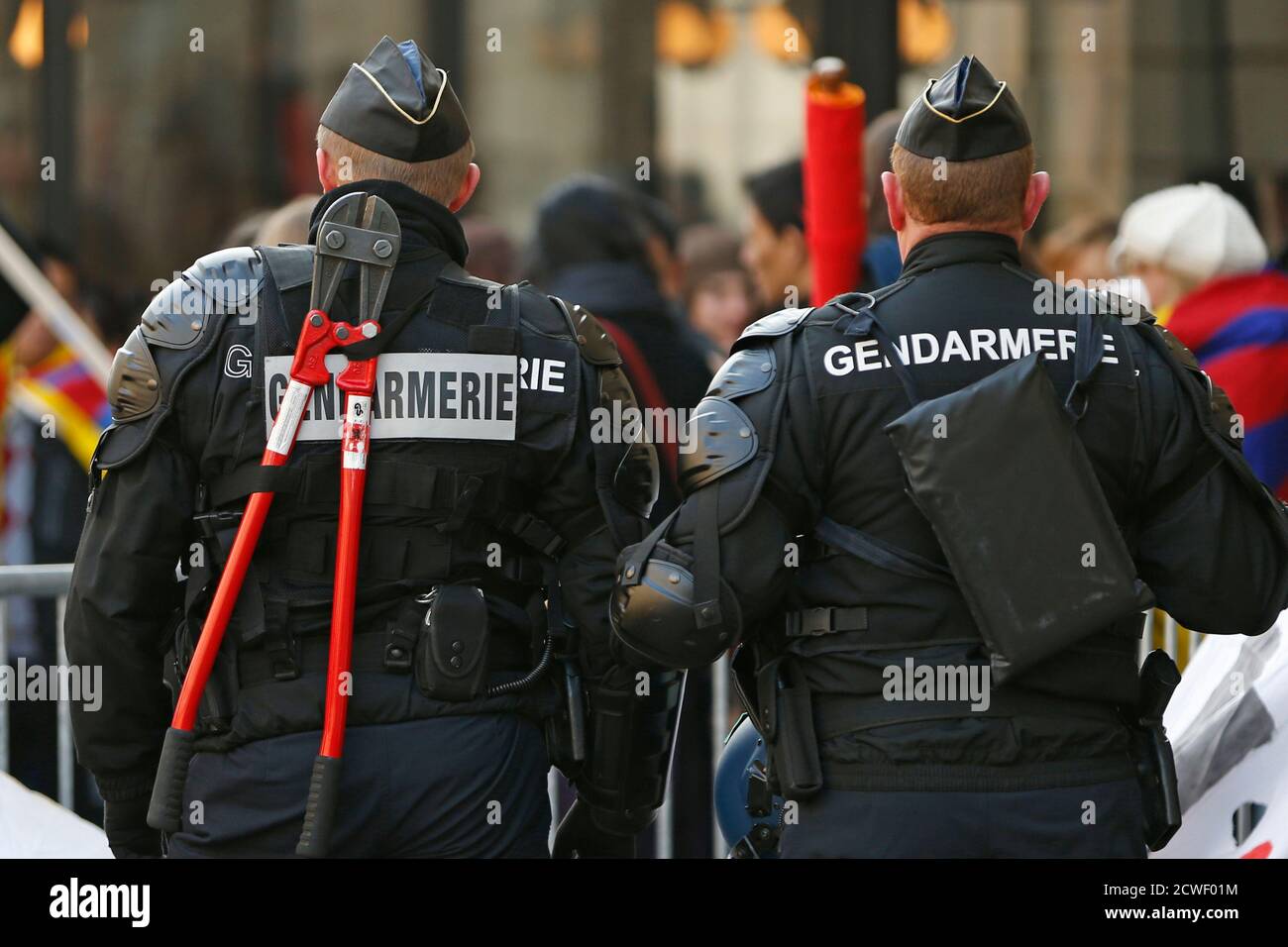 A French gendarme carries a pair of bolt cutters during a demonstration of  Pro-Tibet activists near the Chinese embassy in Paris February 13, 2013.  REUTERS/Charles Platiau (FRANCE - Tags: POLITICS CIVIL UNREST