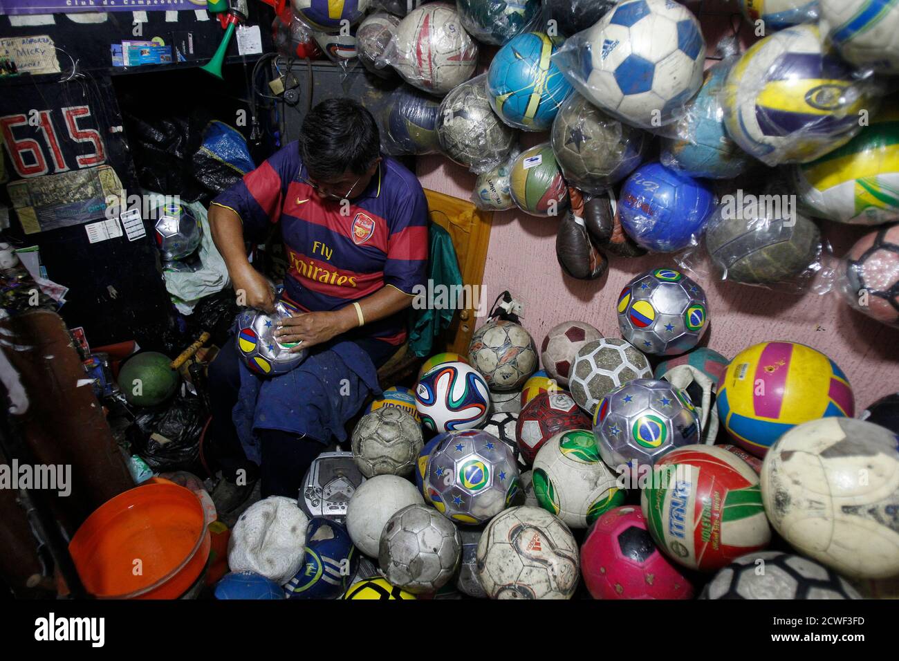 Francisco Valderrama, A Ball Repairer, Fixes A Soccer Ball Inside His Shop  In Lima June 25, 2014. The So Called "Ball Clinics", Which Are Found In The  City's Popular Neighborhoods, Repair Balls