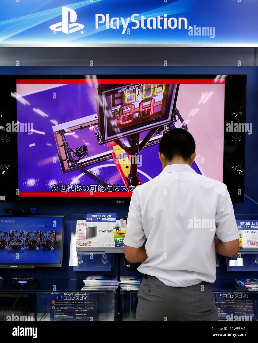 A man plays with Sony Corp's PlayStation 4 console at an electronics retail  store in Tokyo July 16, 2014. Japan's Sony Corp is hammering out plans to  rise from the ashes of