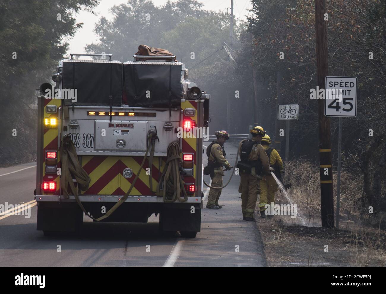 Angwin, United States. 29th Sep, 2020. Firefighters spray a hot spot along the Silverado Trail in Calistoga, California on Tuesday, September 29, 2020. The Glass Fire has burned over 40,000 acres and is only 2% contained. Photo by Terry Schmitt/UPI Credit: UPI/Alamy Live News Stock Photo