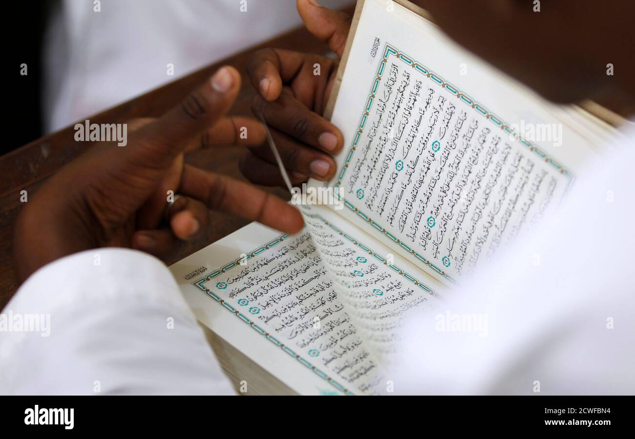 A student reads the Holy Koran during Madrasa class at Al-Nour Islamic school in the historic centre of Stone Town in the Indian Ocean Island of Zanzibar, during the holy month of Ramadan July 21, 2012.  REUTERS/Thomas Mukoya (TANZANIA - Tags: SOCIETY RELIGION EDUCATION) Stock Photo