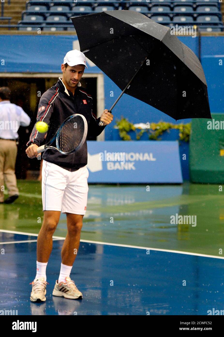 Novak Djokovic of Serbia hits balls during a rain delay at the Toronto  Masters tennis tournament in Toronto August 9, 2012. REUTERS/Mike Cassese  (CANADA - Tags: SPORT TENNIS Stock Photo - Alamy