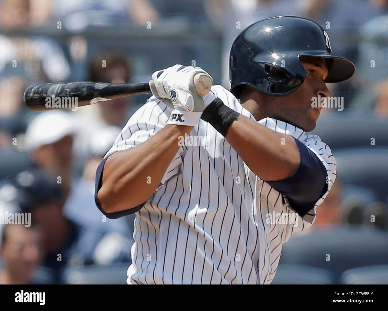 New York Yankees batter Zoilo Almonte hits a two-run single against the Tampa Bay Rays in the third inning of their MLB American League game at Yankee Stadium in New York, June 22, 2013. REUTERS/Ray Stubblebine (UNITED STATES - Tags: SPORT BASEBALL) Stock Photo