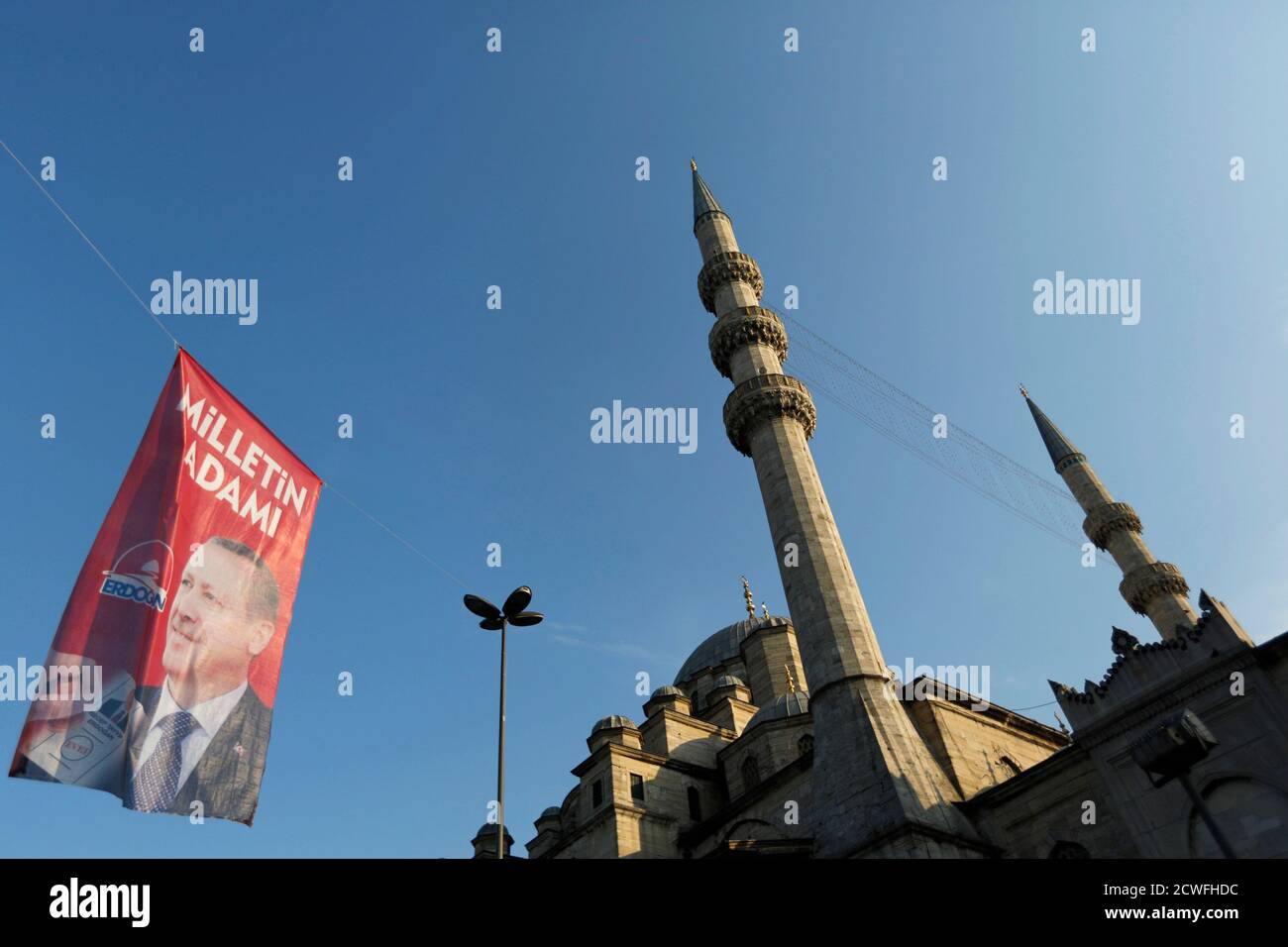 An election campaign banner of Turkey's Prime Minister and presidential candidate Tayyip Erdogan is seen near a mosque in Istanbul August 9, 2014. Erdogan is set to secure his place in history as Turkey's first popularly-elected president on Sunday, but his tightening grip on power has polarised the nation, worried Western allies and raised fears of creeping authoritarianism. REUTERS/Murad Sezer (TURKEY  - Tags: POLITICS ELECTIONS) Stock Photo