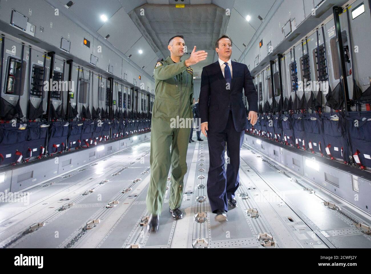 Britain's Prime Minister David Cameron views a newly delivered A400M Atlas aircraft with wing commander Simon Boyle at RAF Brize Norton, central England, November 27, 2014. The RAF will take delivery of 22 of the A400M aircraft. REUTERS/Peter Nicholls (BRITAIN - Tags: POLITICS MILITARY) Stock Photo
