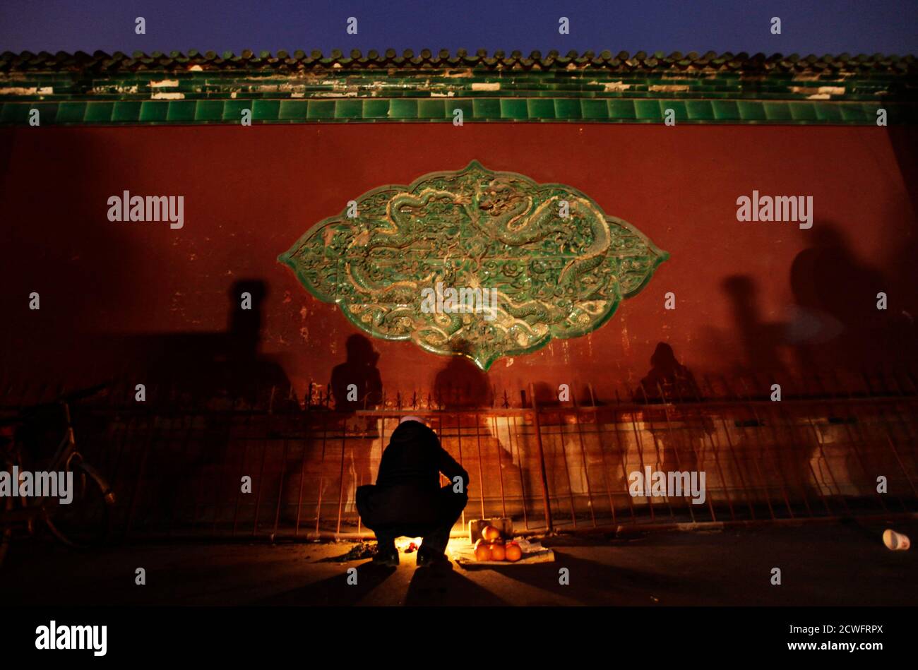 A local resident burns offerings as he prays for good fortune at Dafo temple on the eve of the Lantern Festival, the last day of Chinese Lunar New Year celebrations, in Zhengding County, Hebei province, February 5 , 2012. REUTERS/Jason Lee (CHINA - Tags: SOCIETY ANNIVERSARY TPX IMAGES OF THE DAY) Stock Photo