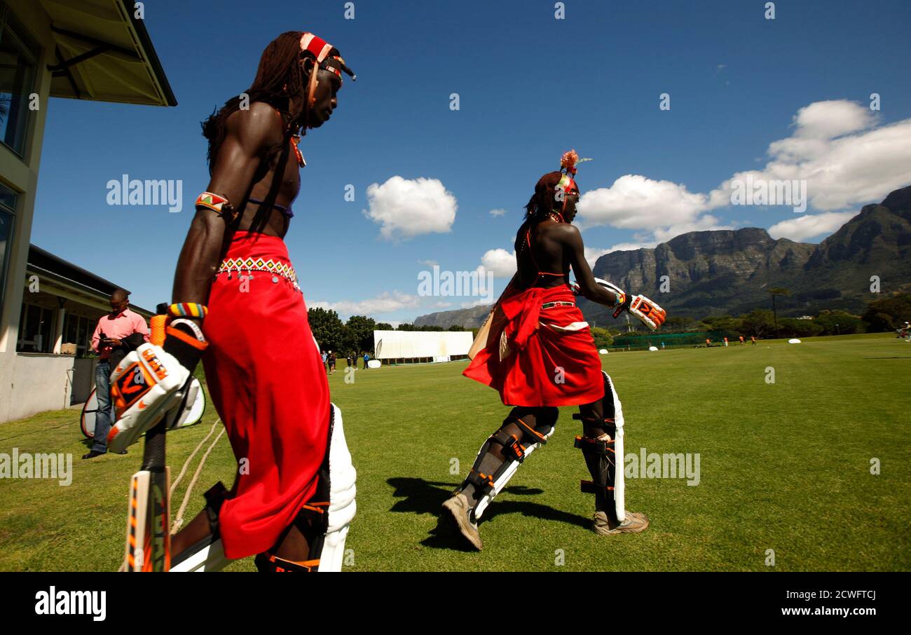 Kenya's Maasai Cricket Warriors players Tapele Ole Naimands (R) and Mulinge Ole Meshami take to the pitch during their 'Last Man Standing' Twenty20 (T20) cricket match against the Cricodillos in Cape Town March 31, 2012. The Maasai Cricket Warriors from Kenya are role models in their communities where they actively campaign against retrogressive and harmful cultural practices, such as female genital mutilation and early childhood marriages, while fighting to eradicate discrimination against women in Maasailand. Through cricket, they hope to promote healthier lifestyles and to also spread aware Stock Photo