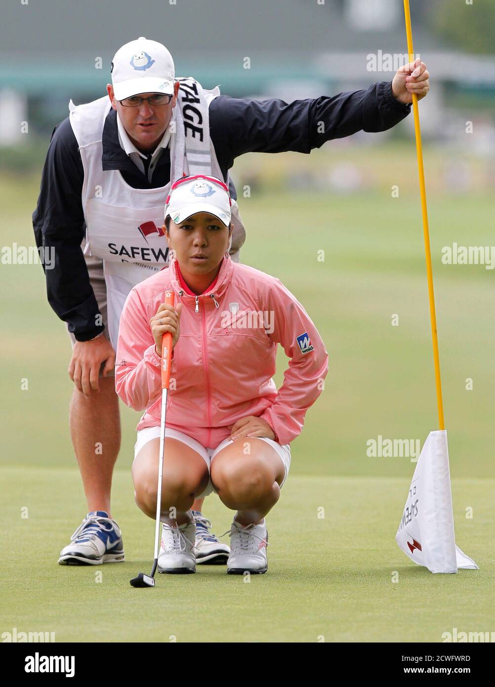 Mika Miyazato Of Japan Lines Up Putt With Her Caddy On The Tenth Hole During Second Round Play At The Lpga Safeway Classic In North Plains Oregon August 18 2012 Reuters Steve Dipaola