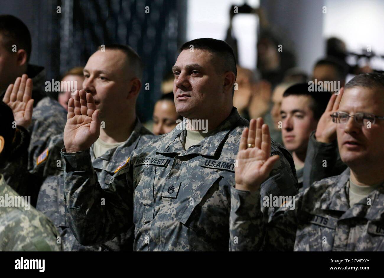 Members of the Pennsylvania National Guard raise their right hand as they are sworn in and receive law enforcement powers for the 57th Presidential Inauguration from a representative of Washington's Metropolitian Police at the DC Armory in Washington, January 18, 2013.   REUTERS/Larry Downing  (UNITED STATES - Tags: POLITICS) Stock Photo