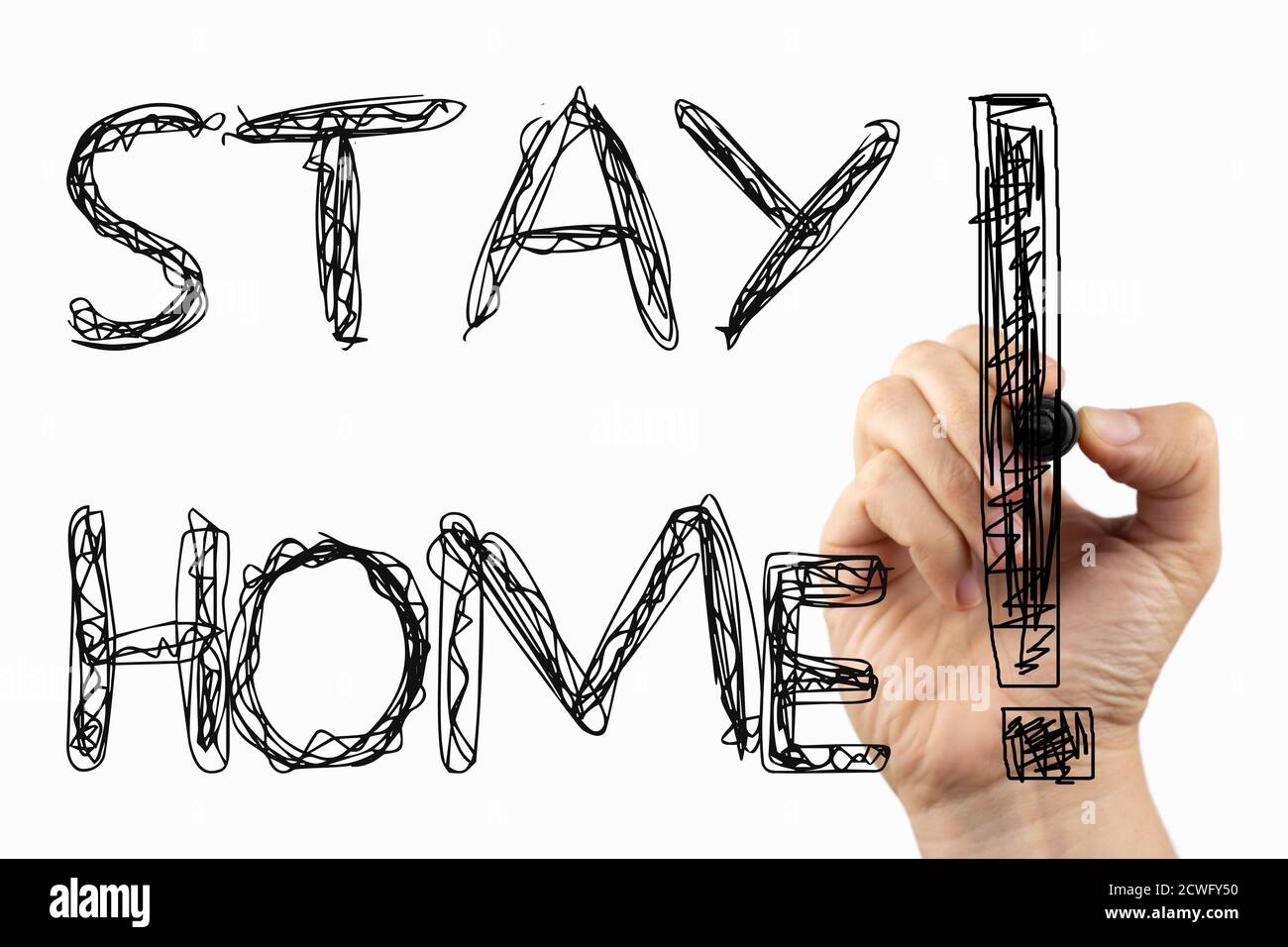 Stay home phrase on a whiteboard, written with black marker in a hand. Stock Photo