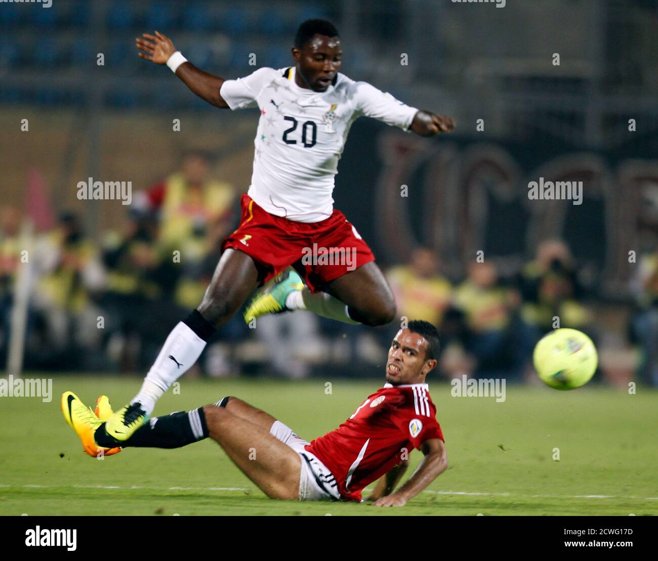 Hazem Emam (bottom) of Egypt fights for the ball with Kwadwo Asamoah of  Ghana during their 2014 World Cup qualifying second leg playoff soccer  match at Air Defence "30 June" stadium in