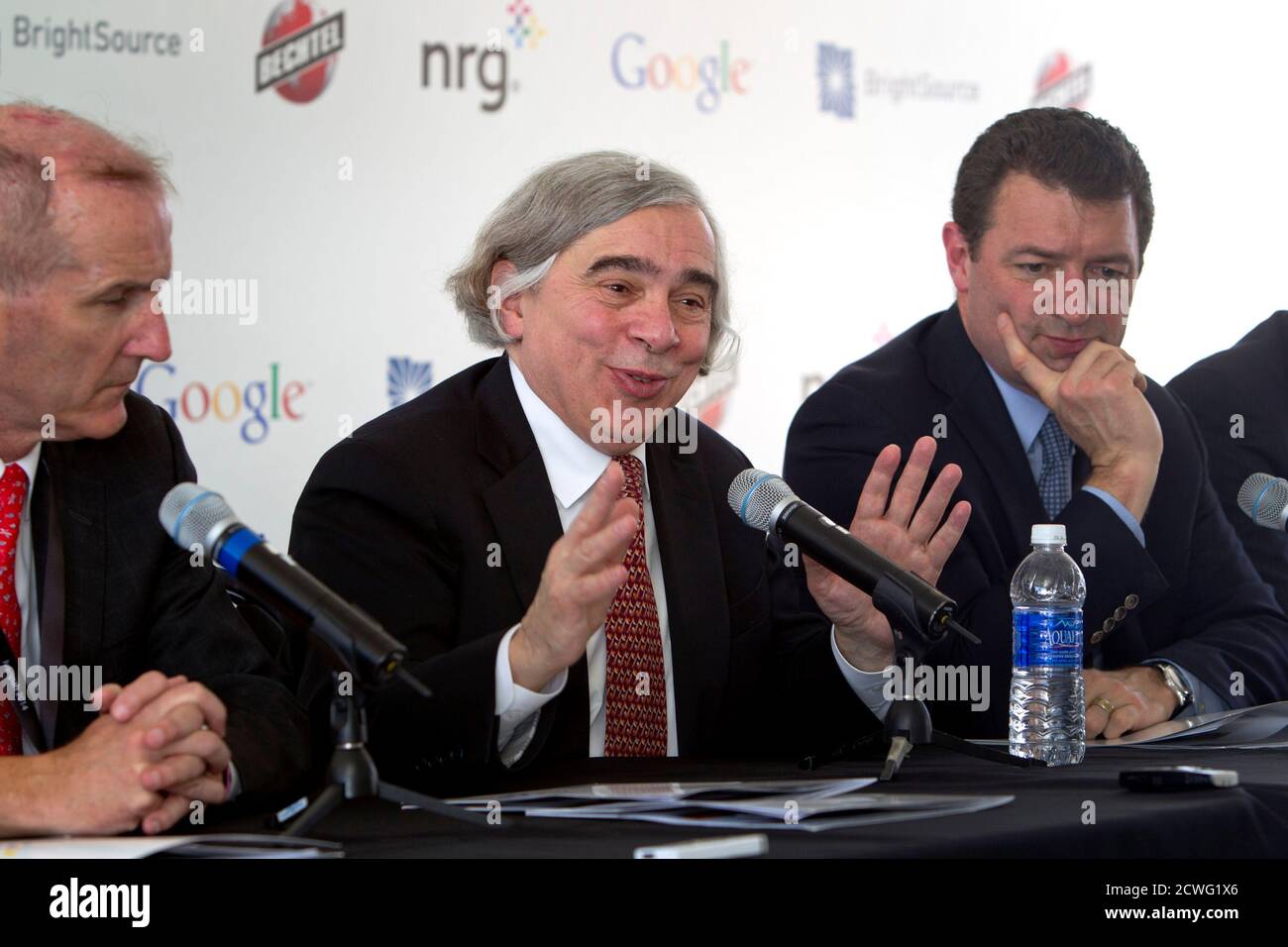 United States Secretary of Energy Ernest Moniz (C) responds to a reporter's question during the grand opening of the Ivanpah Solar Electric Generating System in the Mojave Desert near the California-Nevada border February 13, 2014. The project, a partnership of NRG, BrightSource, Google and Bechtel, is the world's largest solar thermal facility. With Moniz are David Crane (L), president/CEO of NRG, and Toby Seay, president of Bechtel Power. REUTERS/Steve Marcus (UNITED STATES - Tags: ENERGY BUSINESS SCIENCE TECHNOLOGY) Stock Photo