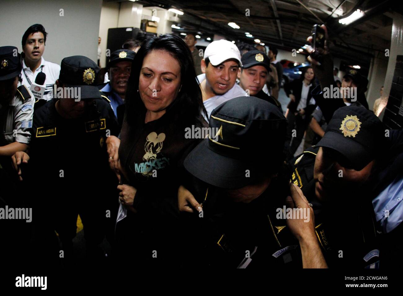 Marlene Blanco Lapola, former Interior vice-minister and former chief of the Guatemalan Police during the years 2008-2012, is escorted by police officers after her arrest for charges of conspiracy and extra-judicial execution in the Supreme Court of Justice of Guatemala City March 23, 2012. Blanco Lapola is charged for cases involving the deaths of three people in relation to extortion of transportation entrepreneurs in operations known as 'social cleansing' in 2009, according to local media. REUTERS/Jorge Dan Lopez (GUATEMALA - Tags: CRIME LAW POLITICS) Stock Photo