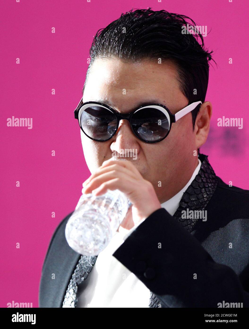South Korean rapper Psy drinks water during a news conference before his  concert in Seoul April 13, 2013. Psy will perform "Gentleman" in public for  the first time on Saturday at a