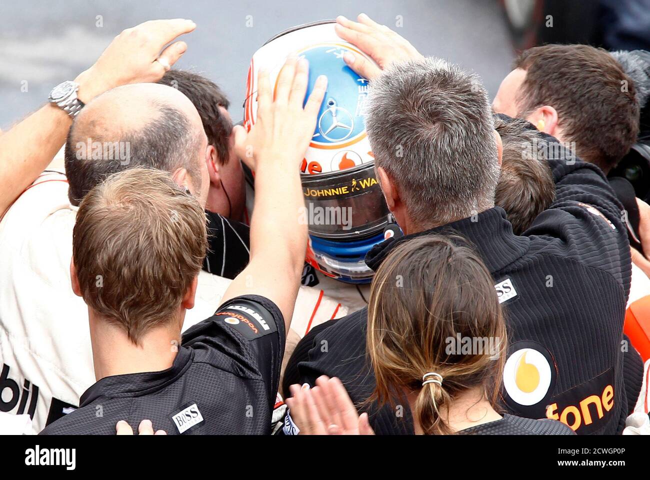 McLaren Formula One driver Jenson Button of Britain is congratulated by his team after winning the Canadian F1 Grand Prix at the Circuit Gilles Villeneuve in Montreal June 12, 2011.     REUTERS/Chris Wattie (CANADA  - Tags: SPORT MOTOR RACING) Stock Photo