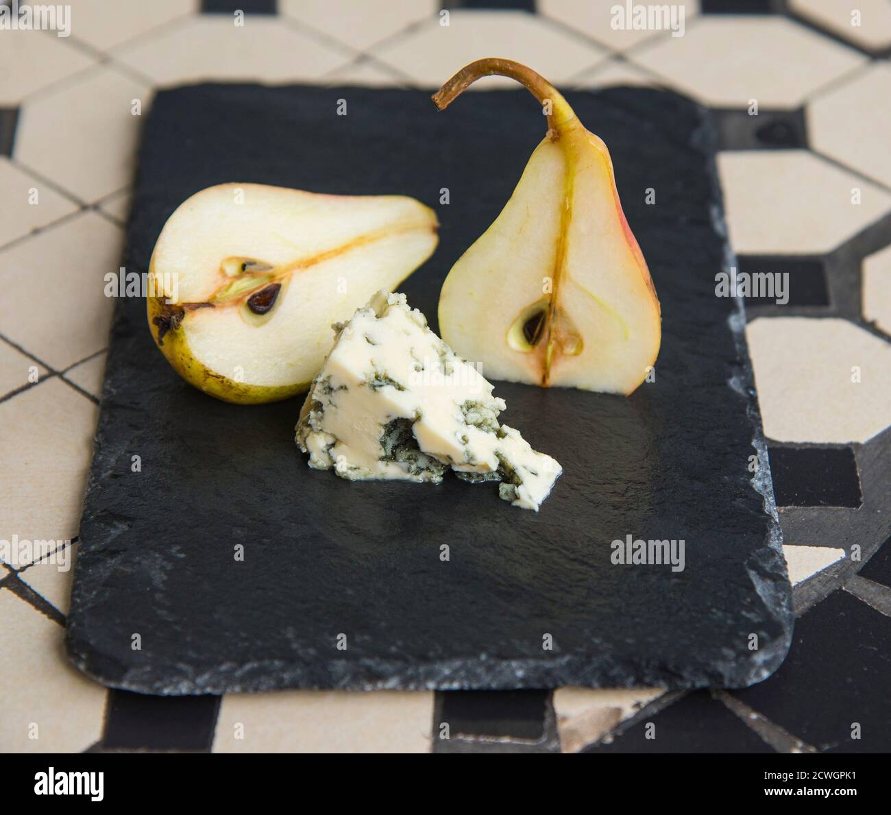 Blue cheese and ripe pears on the black plate Stock Photo
