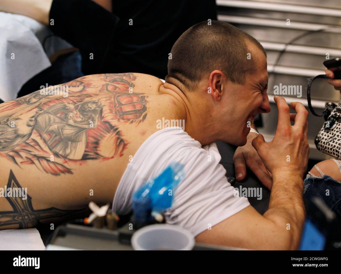 Ron Raucci from Norfolk, Virginia, reacts to the needle while getting his Captain America tattoo at the Hampton Roads Tattoo Festival in Virginia March 2, 2012. Raucci, who serves in the . Ron Raucci from Norfolk, Virginia, reacts to the needle while getting his Captain America tattoo at the Hampton Roads Tattoo Festival in Virginia March 2, 2012. Raucci, who serves in the .